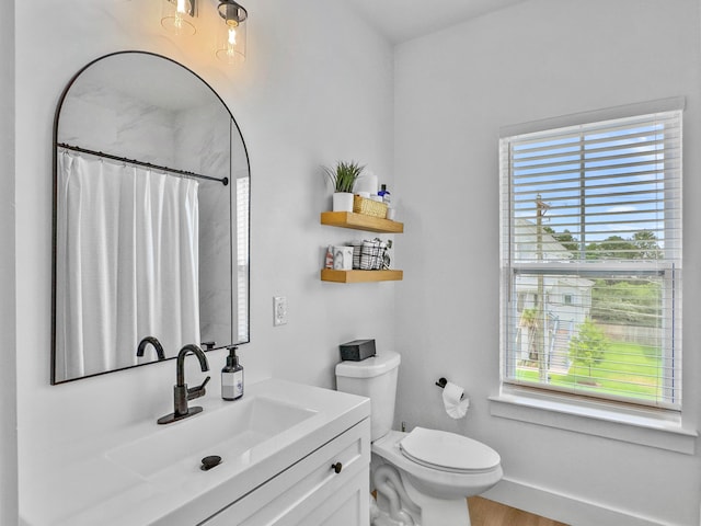 bathroom featuring toilet, vanity, a shower with shower curtain, and hardwood / wood-style flooring