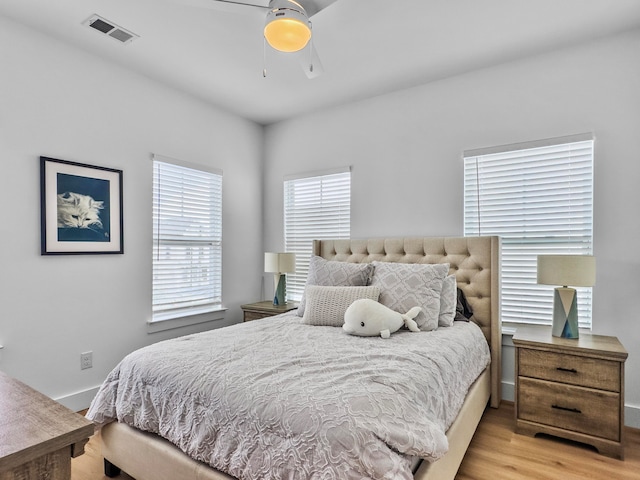 bedroom with light hardwood / wood-style floors and ceiling fan