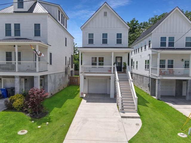 view of front of home with a front lawn, a porch, and a garage