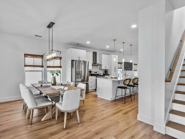 dining room with a chandelier and light wood-type flooring