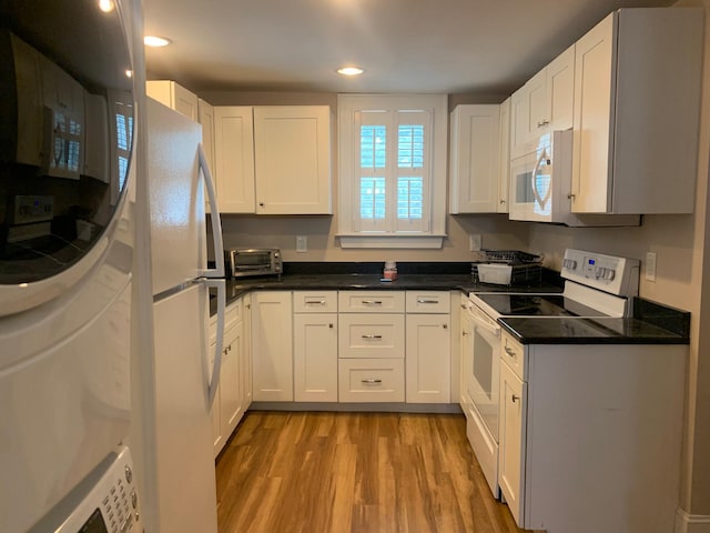 65 Vanderhorst St Unit C, Charleston, SC 29403 - kitchen with white appliances, light wood-style flooring, white cabinetry, and recessed lighting