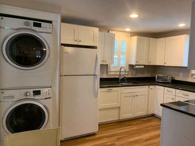 65 Vanderhorst St Unit C, Charleston, SC 29403 - laundry area with stacked washing machine and dryer, recessed lighting, and light wood-type flooring