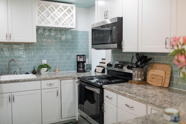 kitchen featuring white cabinetry, sink, and appliances with stainless steel finishes