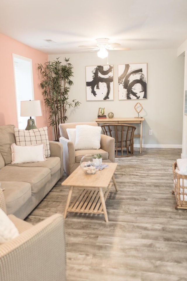 living room featuring ceiling fan and hardwood / wood-style flooring