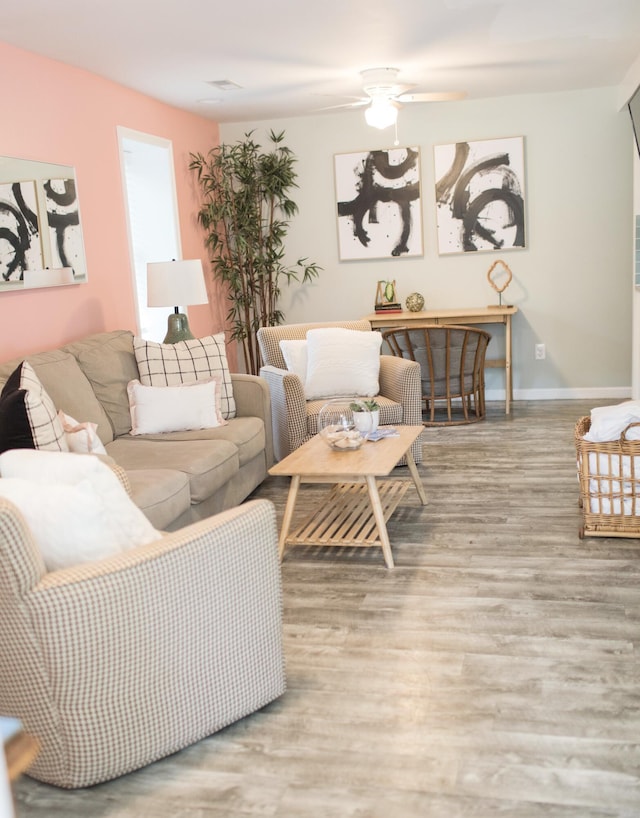 living room featuring light hardwood / wood-style flooring and ceiling fan