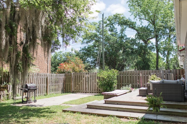 view of yard with an outdoor living space and a deck