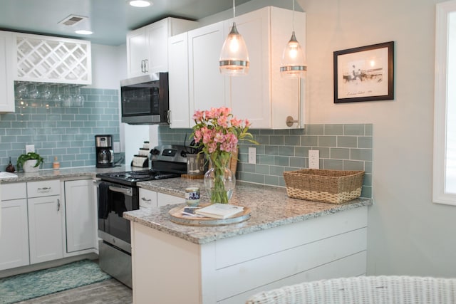 kitchen featuring appliances with stainless steel finishes, tasteful backsplash, decorative light fixtures, light hardwood / wood-style flooring, and white cabinetry