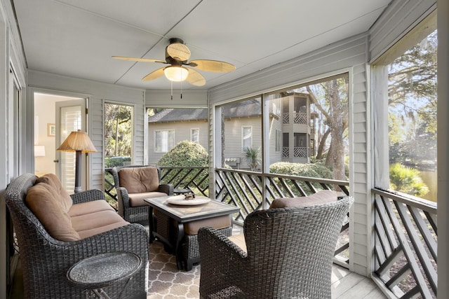 sunroom featuring ceiling fan and a wealth of natural light