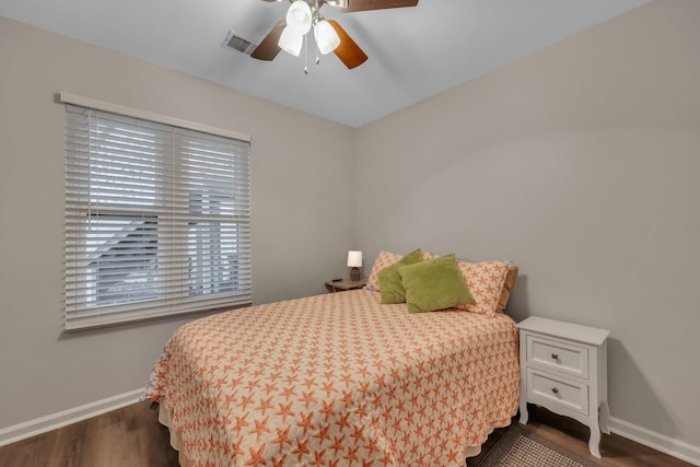 bedroom with dark hardwood / wood-style floors and ceiling fan