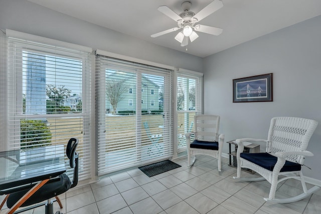 interior space with light tile patterned floors and ceiling fan