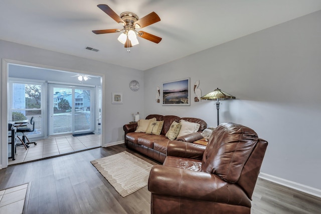 living room with hardwood / wood-style flooring and ceiling fan