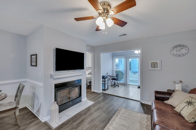 living room with ceiling fan and light hardwood / wood-style floors