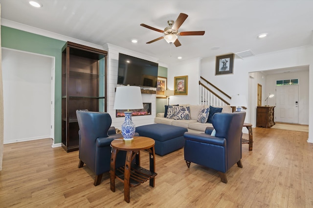 101 Caleb Ct, Ladson, SC 29456 - living room with light wood-type flooring, a fireplace, ceiling fan, crown molding, and recessed lighting
