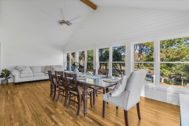 sunroom / solarium featuring vaulted ceiling with beams and ceiling fan