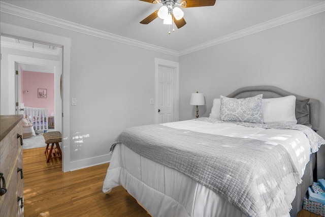 bedroom featuring crown molding, ceiling fan, and dark wood-type flooring