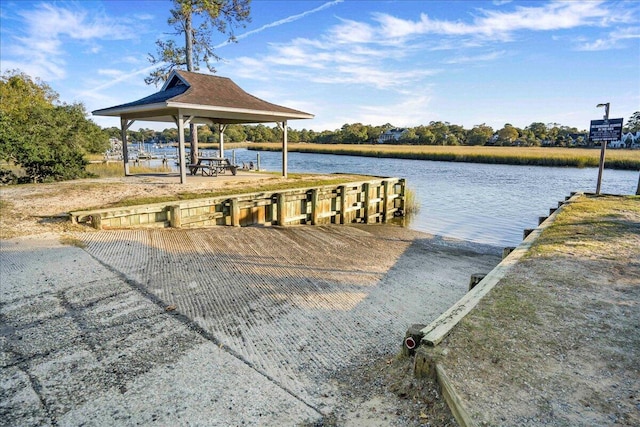 view of dock featuring a gazebo and a water view