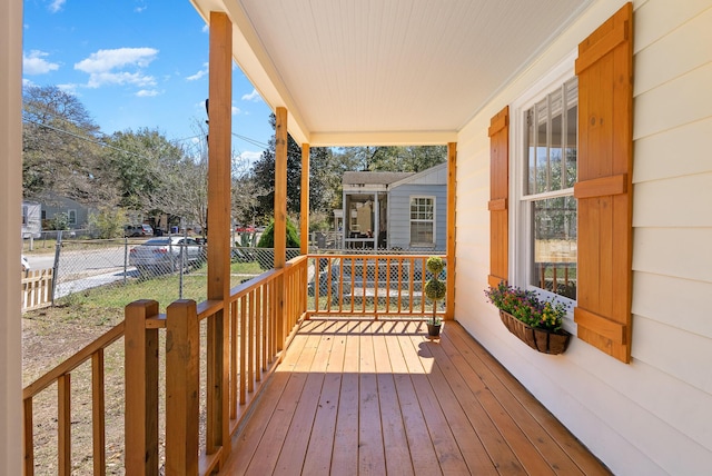 wooden deck featuring fence and covered porch