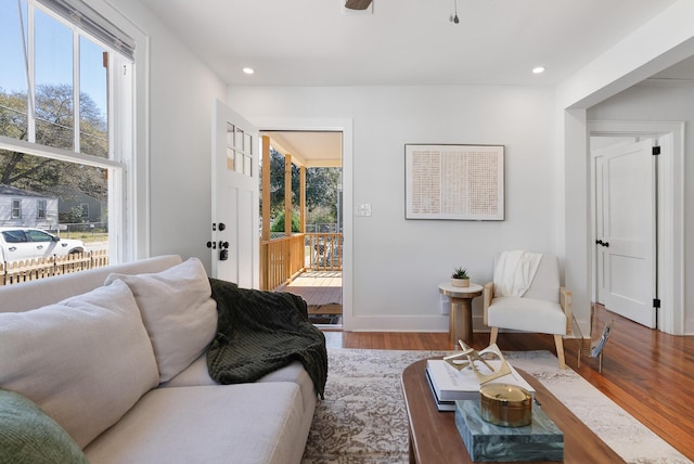 living area with recessed lighting, baseboards, and wood finished floors