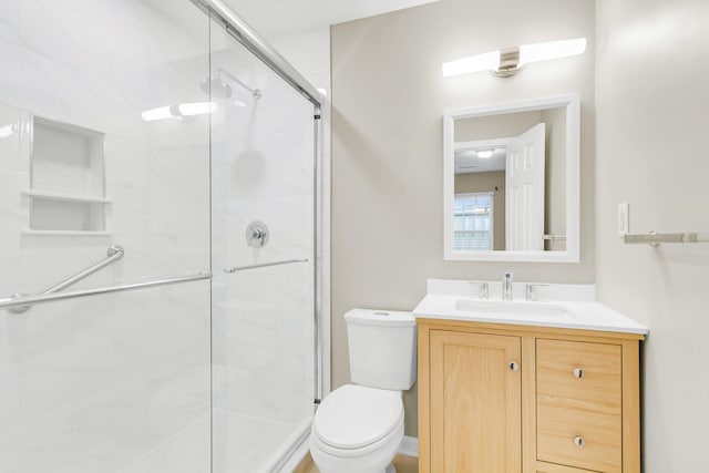 full bathroom featuring vanity, toilet, and a stall shower