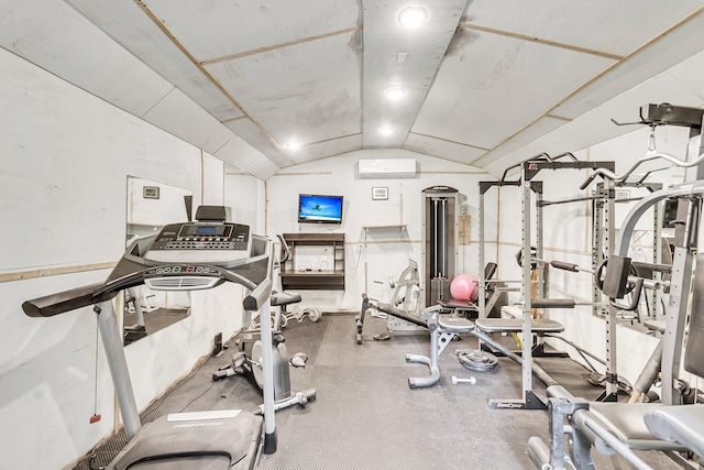 exercise room with lofted ceiling and a wall unit AC