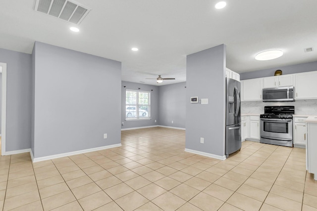 kitchen with visible vents, open floor plan, light countertops, stainless steel appliances, and a ceiling fan