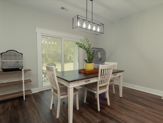 dining area with dark hardwood / wood-style flooring