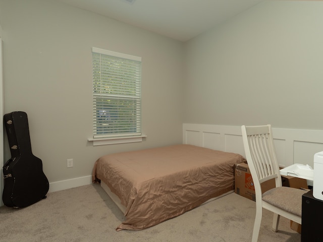 bedroom featuring light carpet