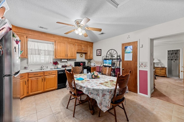 dining area with a textured ceiling, visible vents, a ceiling fan, and light colored carpet