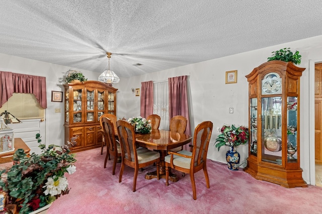 dining room with light carpet, visible vents, and a textured ceiling