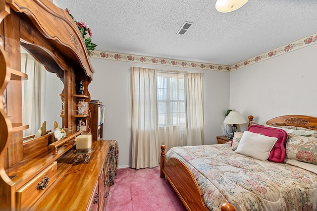 carpeted bedroom with visible vents and a textured ceiling