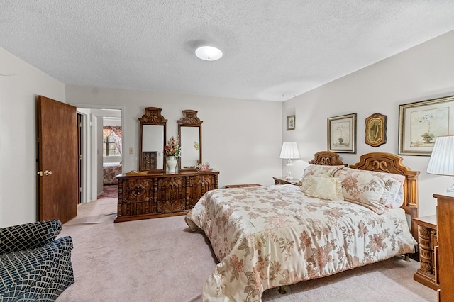 bedroom with a textured ceiling and carpet flooring