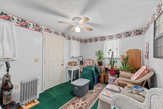 interior space featuring radiator, carpet, ceiling fan, and a textured ceiling