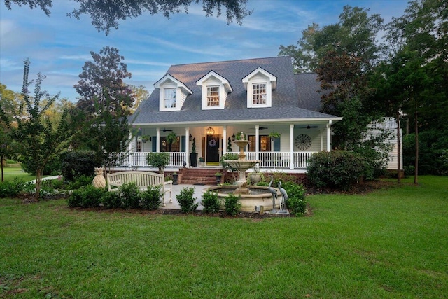 new england style home featuring a front lawn and covered porch