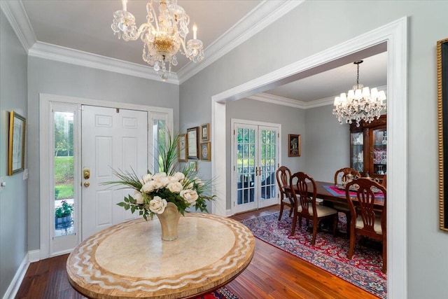 foyer featuring hardwood / wood-style flooring, crown molding, and plenty of natural light