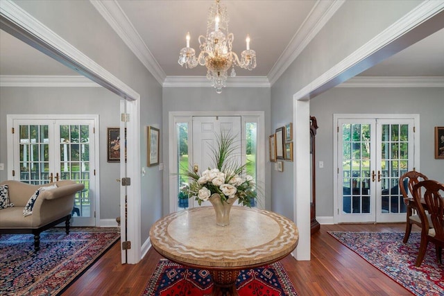 foyer entrance with french doors, hardwood / wood-style floors, a healthy amount of sunlight, and ornamental molding