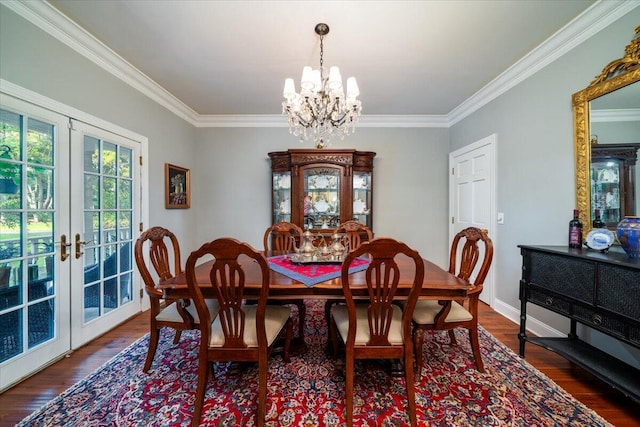 dining area featuring a chandelier, ornamental molding, dark hardwood / wood-style floors, and french doors