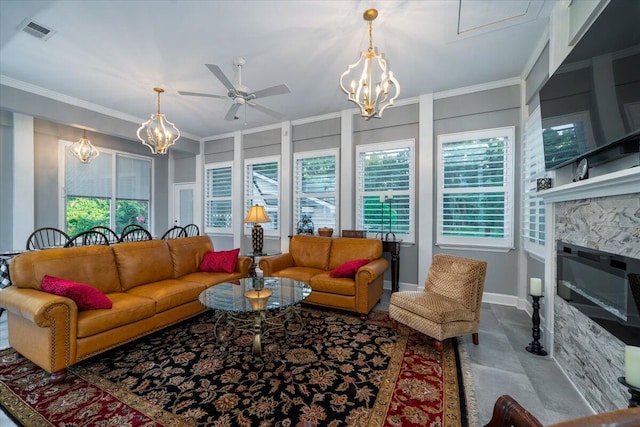 living room featuring ceiling fan with notable chandelier and crown molding