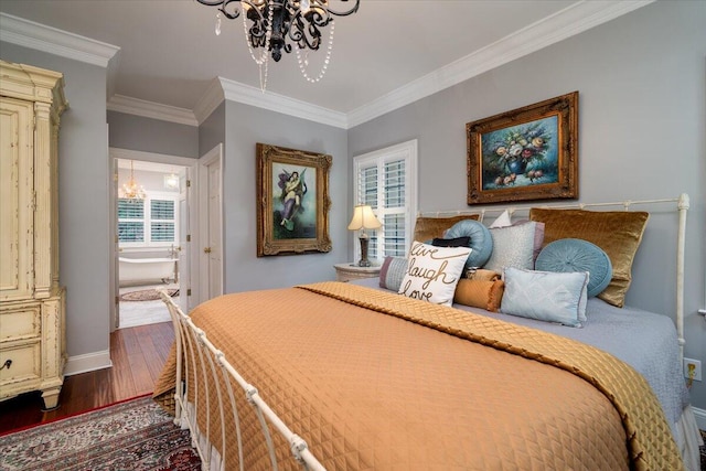 bedroom featuring hardwood / wood-style floors, ornamental molding, ensuite bathroom, and a chandelier