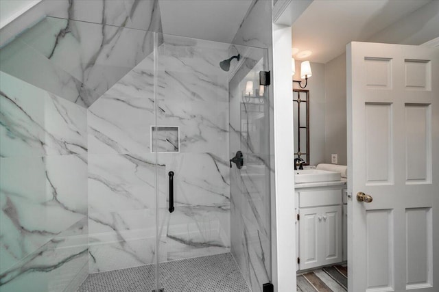 bathroom featuring a shower with door, vanity, and hardwood / wood-style floors