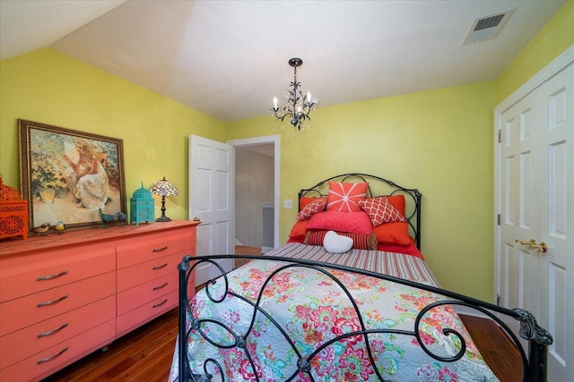 bedroom featuring a notable chandelier and dark hardwood / wood-style floors