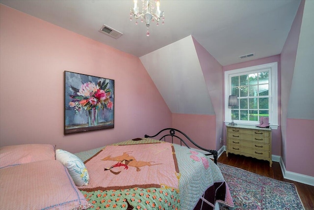 bedroom featuring vaulted ceiling, an inviting chandelier, and dark wood-type flooring