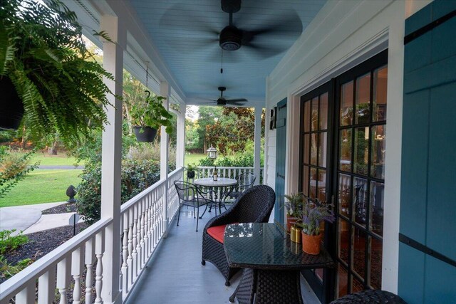 balcony with ceiling fan and a porch