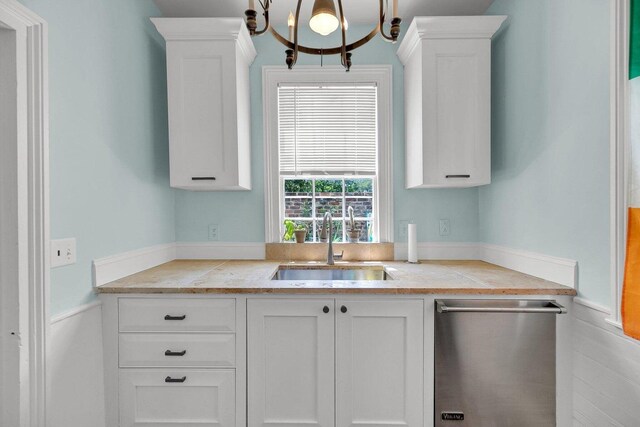 197 Coming St, Charleston, SC 29403 - kitchen with dishwasher, white cabinets, an inviting chandelier, and a sink