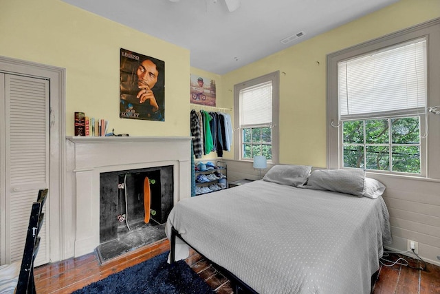 197 Coming St, Charleston, SC 29403 - bedroom featuring wood finished floors, visible vents, and a fireplace