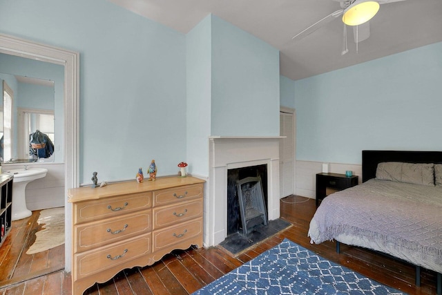 197 Coming St, Charleston, SC 29403 - bedroom with wood-type flooring, a ceiling fan, and a fireplace
