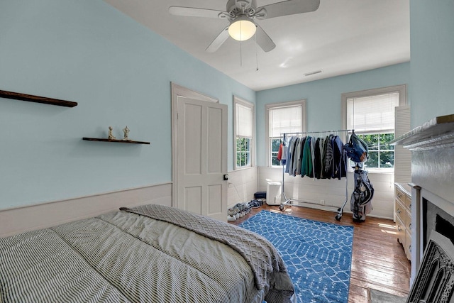 197 Coming St, Charleston, SC 29403 - bedroom with wood finished floors, visible vents, ceiling fan, and wainscoting
