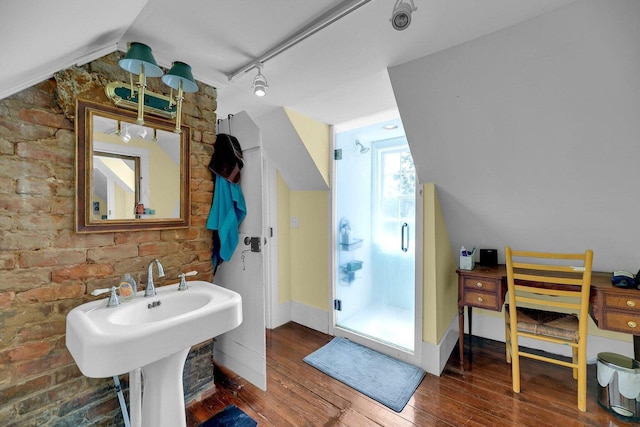 197 Coming St, Charleston, SC 29403 - bathroom featuring a stall shower, hardwood / wood-style flooring, track lighting, baseboards, and lofted ceiling