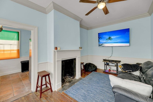 197 Coming St, Charleston, SC 29403 - living room with a fireplace with flush hearth, a ceiling fan, wainscoting, and ornamental molding
