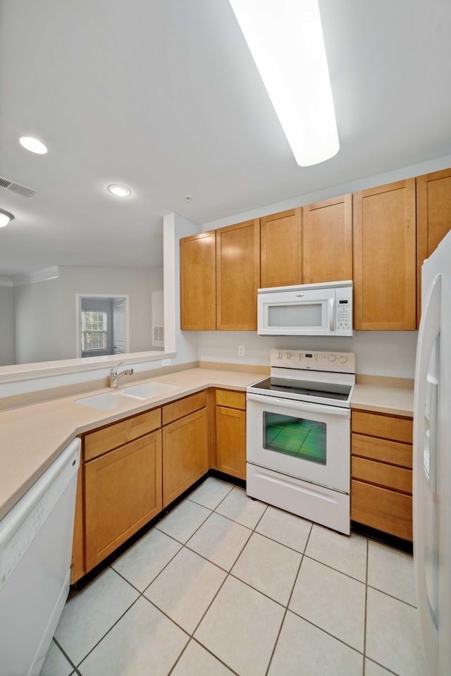 kitchen with light tile patterned floors, white appliances, and sink