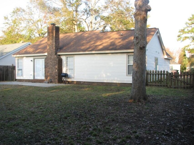 315 Indigo Rd, Goose Creek, SC 29445 - back of house with a chimney, fence, and a lawn